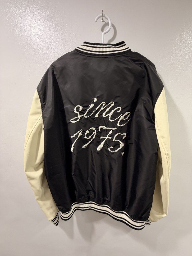 Zara Black and White Varsity Jacket (Category: Coats, Jackets and Outerwear) located in Manila. Submitted by gynzixela (Listing ID 1466204824, Image 2). Description: - Brand: Zara - Style: Varsity / Bomber Jacket - Color: Black body with off-white faux leather sleeves - Closure: Snap button front - Details: Embroidered chest patches with 'I never forget where I come from, I never forget where I'm going' text - Back Design: 'Since 1975' embroidere