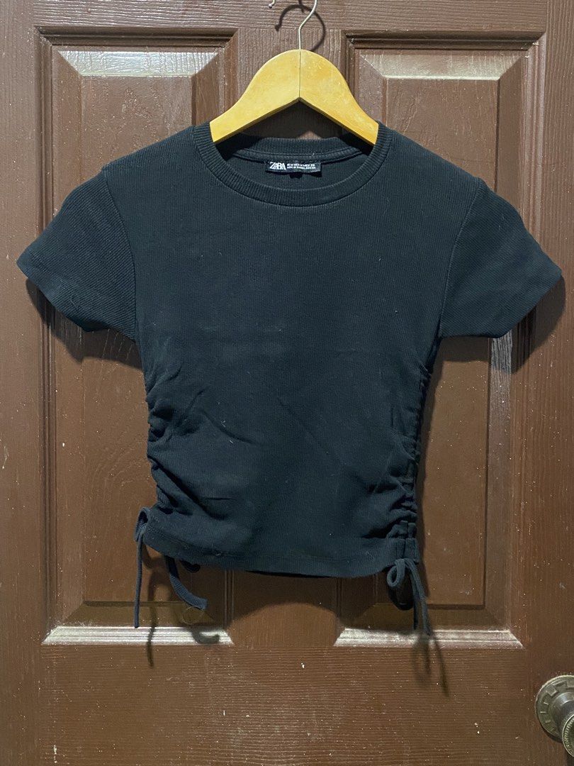 Zara Black Ruched Crop Top (Category: Shirts) located in Calamba. Submitted by soleilcollections.ph (Listing ID 1466237328, Image 1). Description: - Brand: Zara - Size: M - Color: Black - Details: Short sleeves, round neckline, adjustable side drawstrings for a ruched/cinched look - Fabric: Highly stretchy and comfortable - Condition: Worn a few times, solid shape - Style tip: Easy to pair with high-waisted jeans or skirts for a casual chic outfi