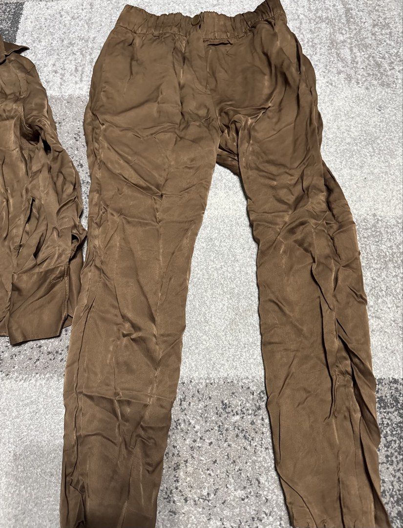 Zara Brown Silk-Feel Button-Down Shirt and Pants Set (Category: Sets or Coordinates) located in Manila. Submitted by prelovedshop0818 (Listing ID 1466322477, Image 3). Description: - Brand: Zara - Set includes: Button-down long sleeve shirt and matching trousers - Material: Silk-like fabric with a subtle sheen - Pants features: Elastic waistband with button closure - Color: Versatile neutral brown - Condition: Sold as a complete set.