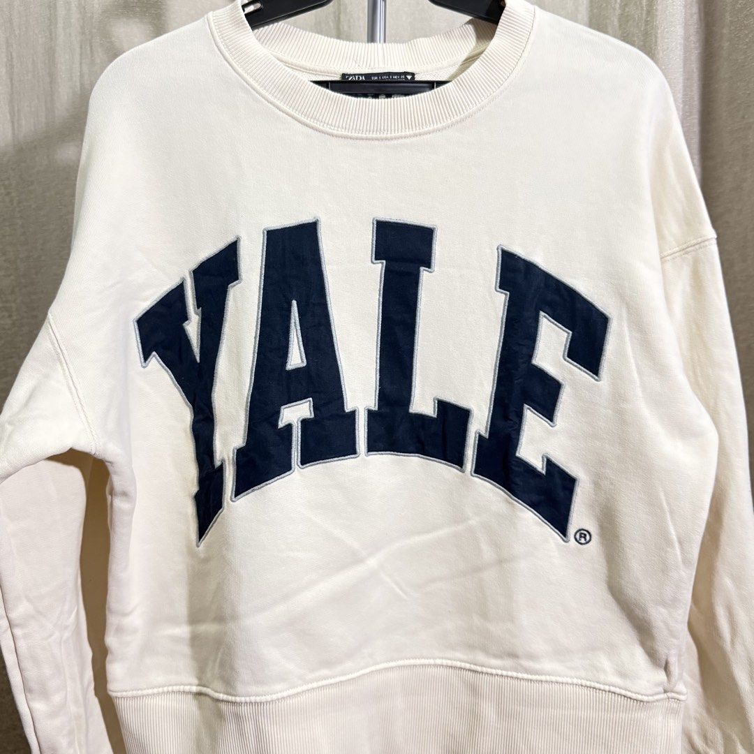 Zara Sweatshirt (Category: Coats, Jackets and Outerwear) located in Manila. Submitted by she_alice (Listing ID 1466325211, Image 1). Description: - Brand: Zara - Style: Off-white crewneck sweatshirt with navy blue Yale - Size: S - Material: Comfortable cotton blend - Details: Ribbed collar, cuffs, and hem - Flaw: minor stain at the back -Super pretty in actual. 💬 Feel free to message me for any questions 🛵 Can be shipped via Lalamove .
