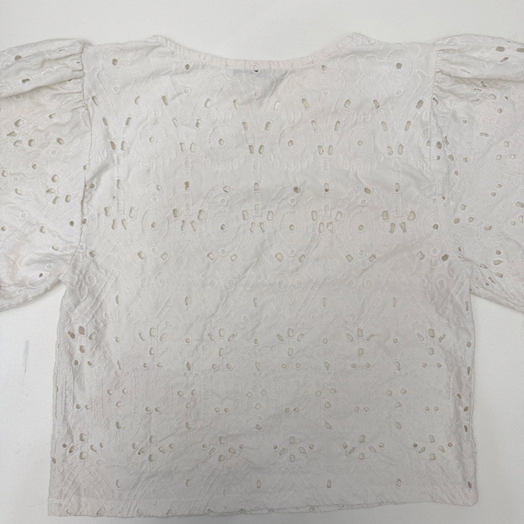 Zara White Eyelet Puff Sleeve Top Size M (Category: Blouses) located in Pasig City. Submitted by boymom20 (Listing ID 1466201754, Image 2). Description: - Brand: Zara - Size: M - Color: White - Details: Intricate eyelet embroidery, short puff sleeves, round neckline - Fabric: Lightweight and breathable, perfect for warm weather - Condition: Clean, neatly folded, and ready to ship LAST PRICE POSTED + 75 SHIPPING FEE VIA J&T.