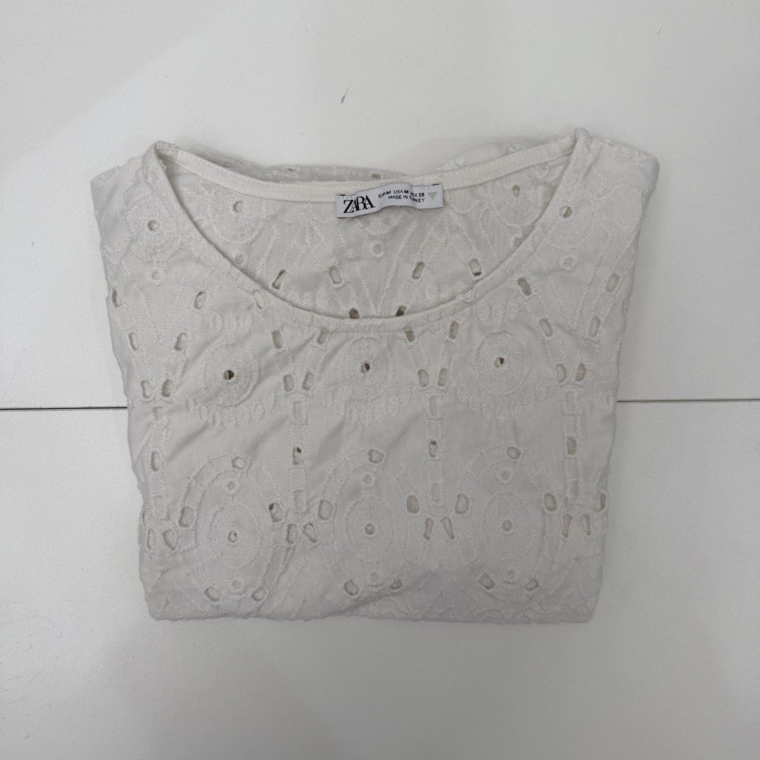 Zara White Eyelet Puff Sleeve Top Size M (Category: Blouses) located in Pasig City. Submitted by boymom20 (Listing ID 1466201754, Image 3). Description: - Brand: Zara - Size: M - Color: White - Details: Intricate eyelet embroidery, short puff sleeves, round neckline - Fabric: Lightweight and breathable, perfect for warm weather - Condition: Clean, neatly folded, and ready to ship LAST PRICE POSTED + 75 SHIPPING FEE VIA J&T.