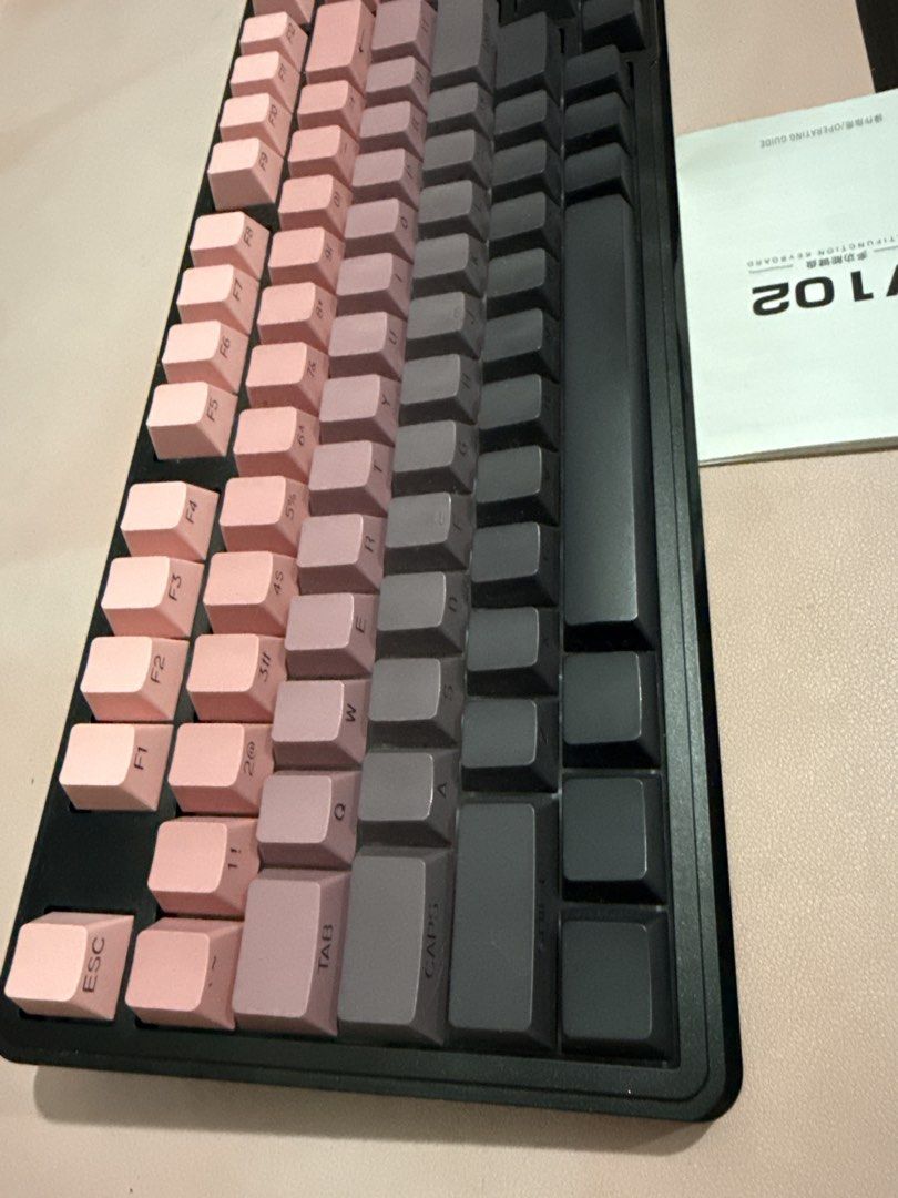 Zeus V102 Mechanical Keyboard Gradient Pink Grey (Category: Computer Keyboard) located in Muntinlupa City. Submitted by itsraas (Listing ID 1466297504, Image 3). Description: - Model: Zeus V102 Mechanical Keyboard - Condition: Tested and 100% fully working - Design: Stylish gradient keycaps transitioning from pink to dark grey with a solid black frame casing - Layout: Compact design complete with a numeric keypad section - Extra Feature: Handy ro