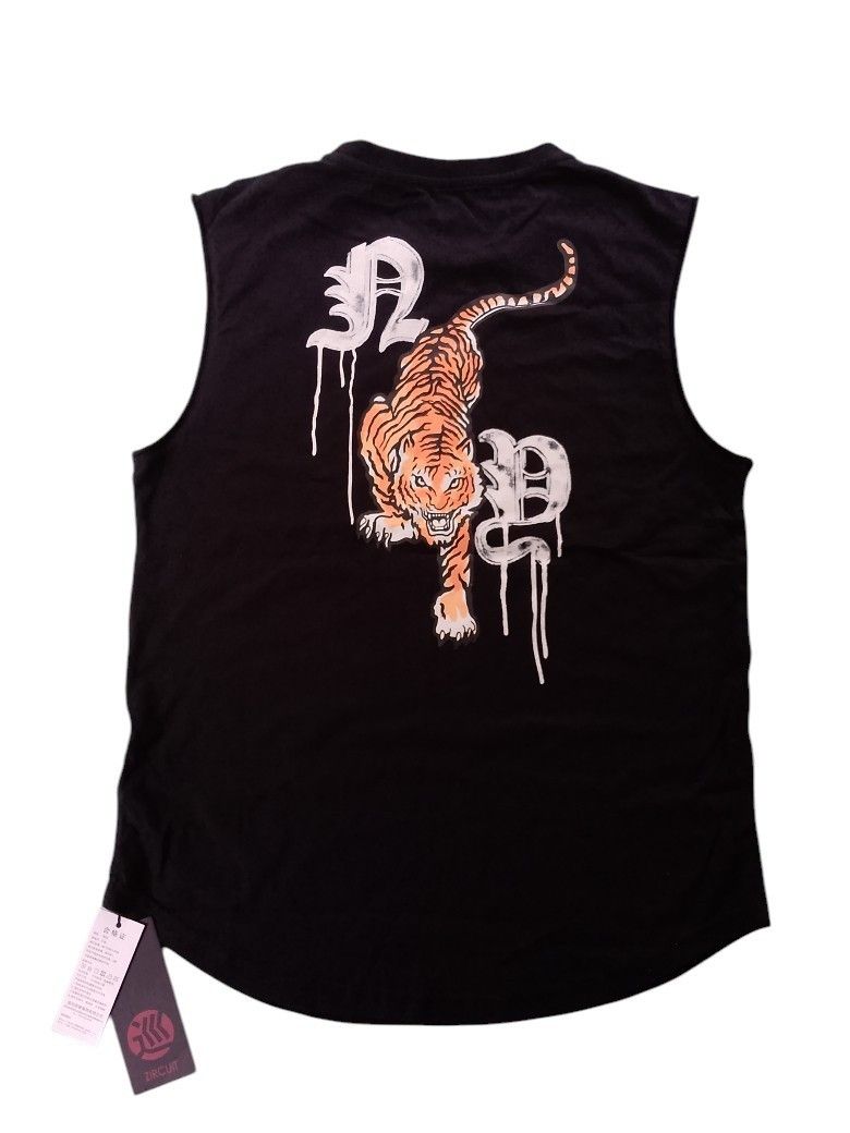 ZIRCUIT Black Tiger Graphic Tank Top (Category: Vests) located in Manila. Submitted by poisonthrift (Listing ID 1466225183, Image 2). Description: - Brand: ZIRCUIT - Condition: Brand new with tags attached - Color: Black - Style: Sleeveless tank top with a curved hem - Front Detail: White dripping letter graphic on the chest - Back Detail: Large tiger graphic with white lettering - Perfect for casual wear and street style.