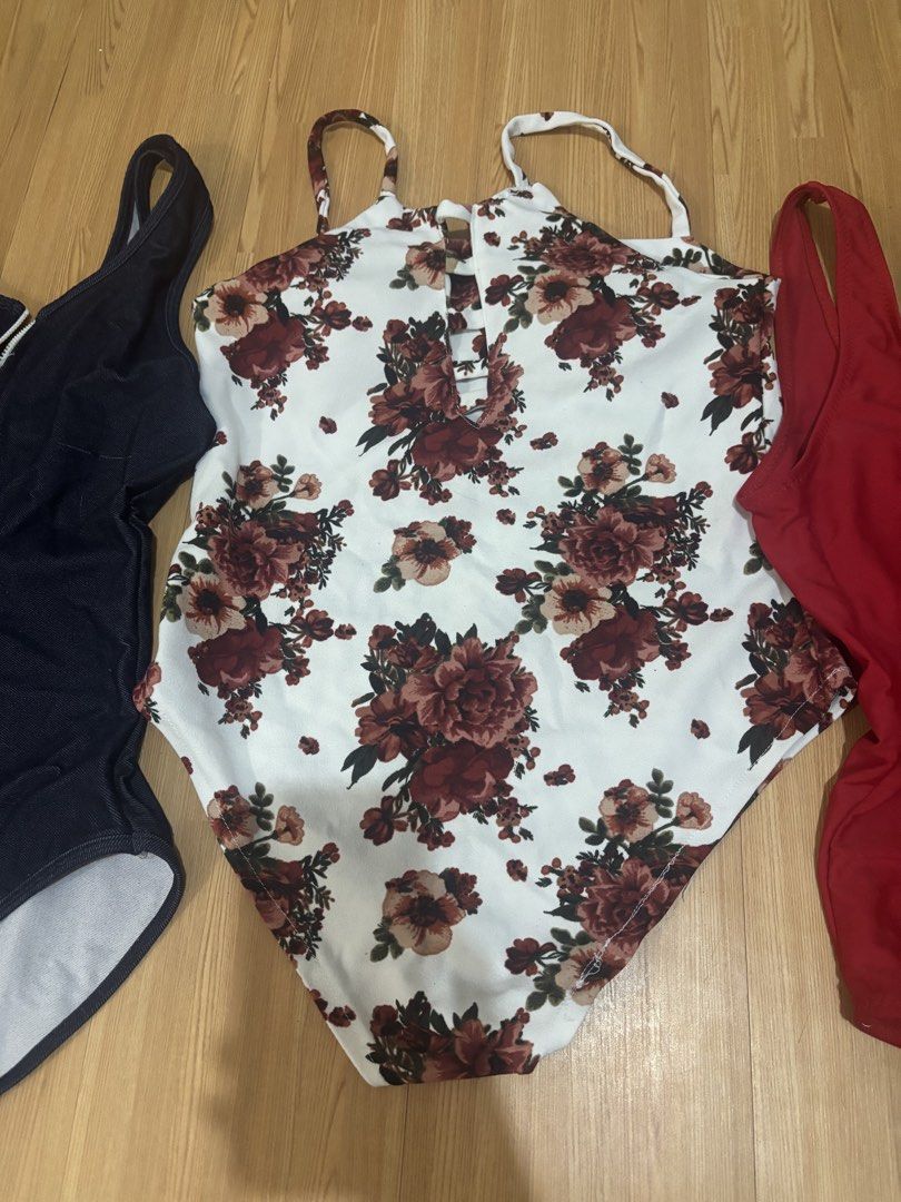 5 swimsuit TAKE ALL! (Category: Bikinis & Swimsuits) located in Manila. Submitted by jobithings (Listing ID 1466443737, Image 1). Description: - 4-piece women's swimsuit bundle - White one-piece with red floral pattern and front keyhole cutout - Solid red scoop neck one-piece - Black zippered one-piece with a denim-look finish - Two-piece set featuring a ribbed pink top and matching tie-side bottoms - Clean, well-maintained, and ready to wear - P