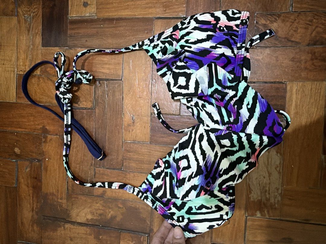 Abstract Print Halter Bikini Top (Category: Bikinis & Swimsuits) located in Manila. Submitted by wearagainfinds (Listing ID 1466411587, Image 1). Description: - Style: Halter neck bikini top with flounce overlay - Print: Multi-color abstract with geometric shapes (purple, black, white, teal) - Straps: Solid navy blue with adjustable neck and back ties - Condition: Clean inside and out, beach-ready - Size: Standard adjustable fit.