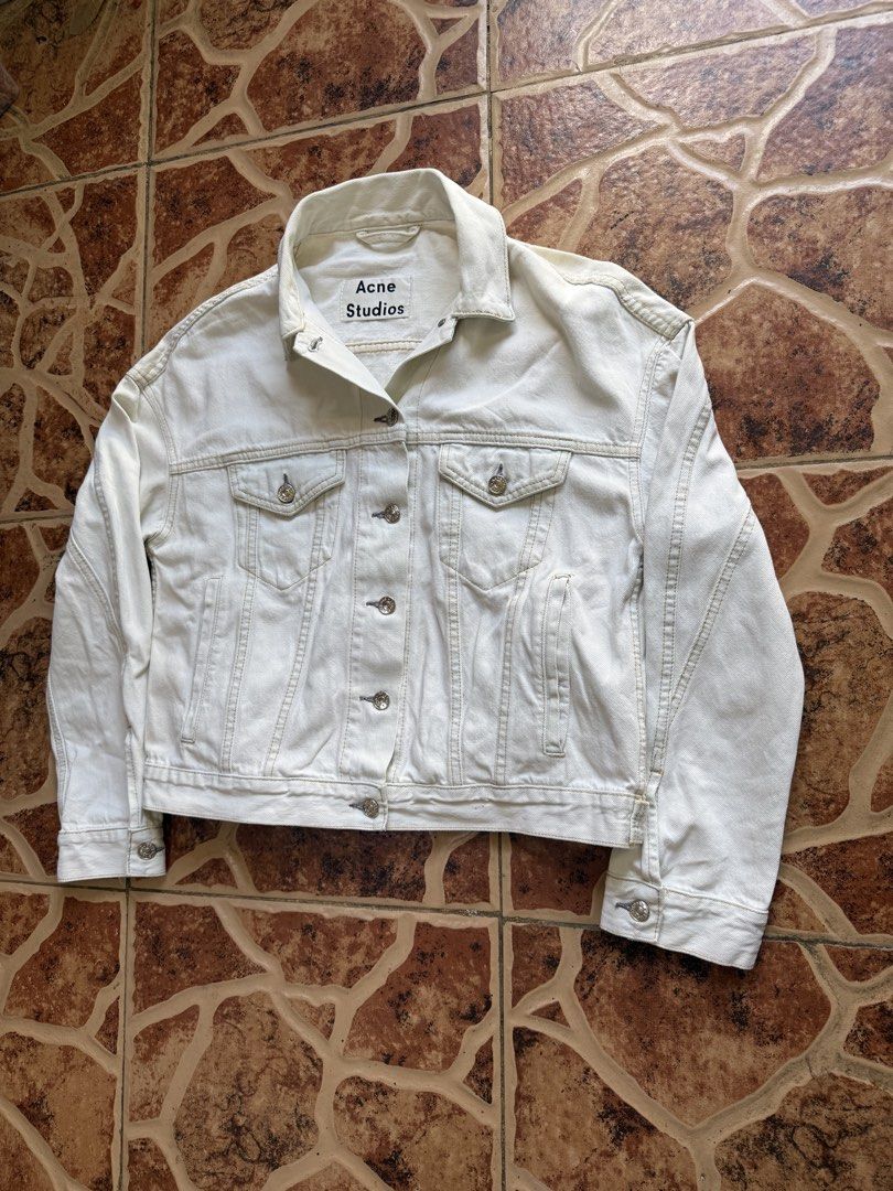 Acne Studios Denim Jacket “Authentic” (Category: Coats, Jackets and Outerwear) located in Cavite. Submitted by stolengoods116 (Listing ID 1466376045, Image 3). Description: Acne Studios denim jacket in an off-white or cream wash. Classic trucker style with button closure, chest flap pockets, and side welt pockets. Contrast stitching throughout with branded metal buttons. Heavy cotton denim material, structured fit with drop shoulders. Minimalist 