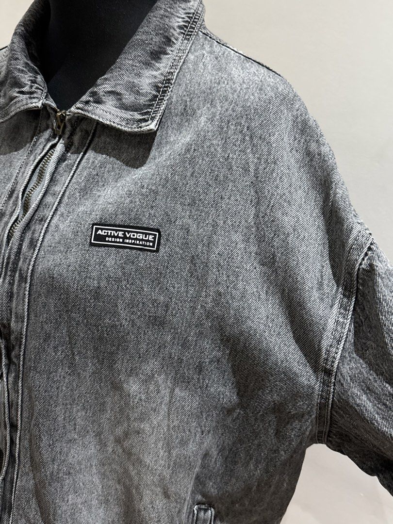 Active Vogue Grey Acid Wash Denim Zip Jacket (Category: Coats, Jackets and Outerwear) located in Manila. Submitted by mpt99876 (Listing ID 1466522593, Image 3). Description: - Colour: Grey acid wash - Fit: Relaxed, oversized with dropped shoulders - Closure: Full front zipper with classic collar - Details: Small black Active Vogue patch on left chest - Hem: Elasticated bottom hem - Sleeves: Long sleeves with solid grey back.
