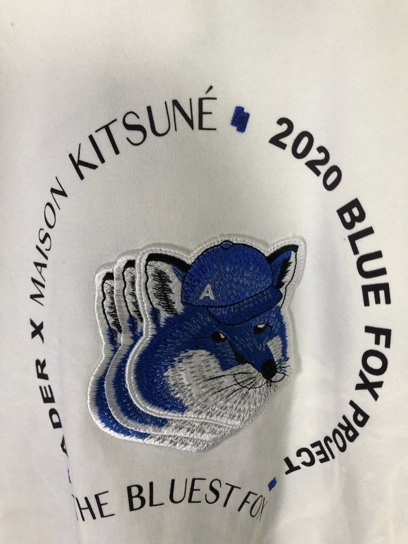 Ader Error x Maison Kitsune Blue Fox Project Sweatshirt (Category: Coats, Jackets and Outerwear) located in Quezon City. Submitted by clarizedeo09960 (Listing ID 1466502689, Image 2). Description: - Brand: Ader Error x Maison Kitsune Collaboration - Color: White - Material: Premium cotton - Design: Large embroidered blue fox graphic with circular typography - Details: Ribbed collar, cuffs, hem, and iconic blue brand tag - Size: Tagged A1 - Origin
