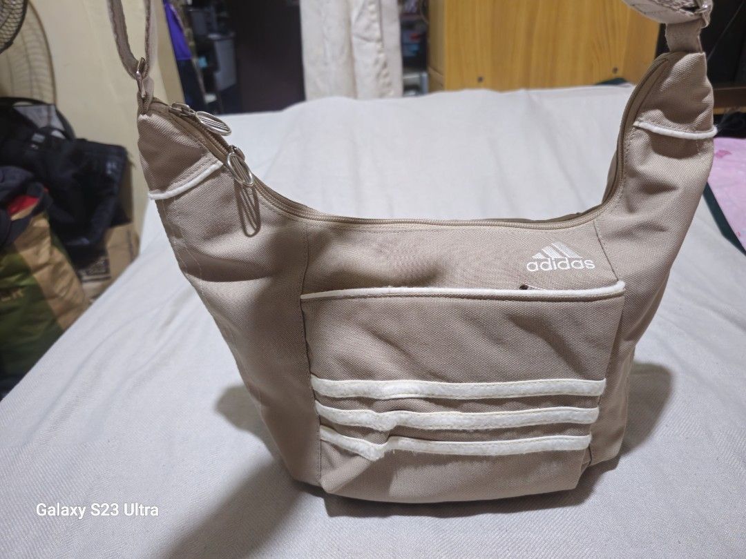 Adidas Authentic Sling/Body Bag (Category: Tote Bags) located in Quezon City. Submitted by bagsforless16 (Listing ID 1466489643, Image 1). Description: Front Zip Compartment Main Zip Compartment with Organizer Back Zip Compartment With Tags and Logos Adjustable Strap Lightweight Denim Very Clean In & Out Size: 15" x 8" x 5".