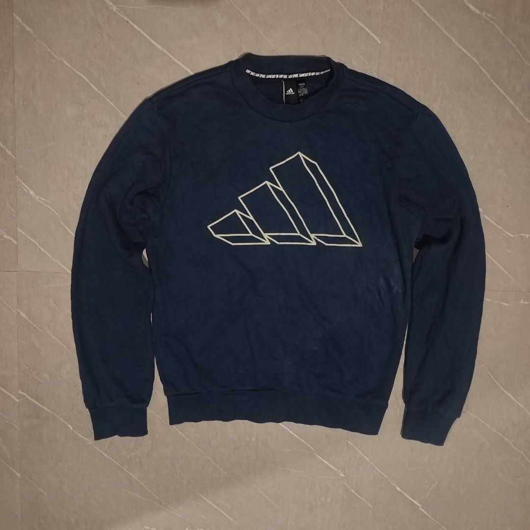 Adidas Blue Graphic Sweatshirt Size M (Category: Coats, Jackets and Outerwear) located in Davao. Submitted by vernoneighty4 (Listing ID 1466482471, Image 2). Description: - Brand: Adidas - Color: Dark blue - Size: US Medium / W20.5 L25Asia S (175/92A) - Design: Large 3D line graphic on chest with 'ANY DAY. I AM SPORT.' neck tape - Details: Ribbed collar, cuffs, and hem - Origin: Made in Cambodia - Condition: Great casual wear for cooler weather.