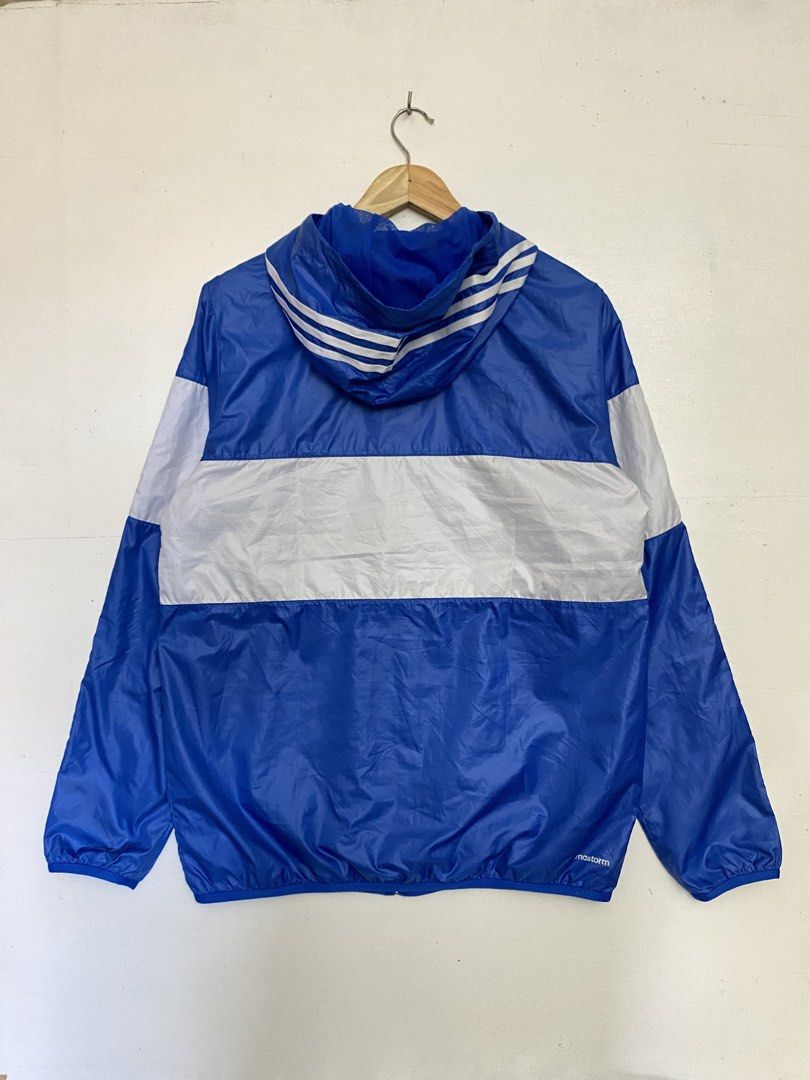 Adidas Blue White Hooded Windbreaker Jacket (Category: Coats, Jackets and Outerwear) located in Cagayan de Oro. Submitted by stllht (Listing ID 1466452192, Image 2). Description: - Brand: Adidas - Color: Classic blue and white color block - Size: L-XL fit -dimes: 22x27.5 - Features: Full zip front, matching hood, zipped side pockets, and breathable mesh lining - Design: Iconic three stripes on sleeves - Condition: Lightweight, perfect for outdoor