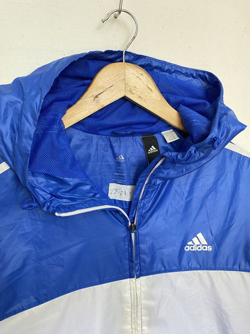 Adidas Blue White Hooded Windbreaker Jacket (Category: Coats, Jackets and Outerwear) located in Cagayan de Oro. Submitted by stllht (Listing ID 1466452192, Image 3). Description: - Brand: Adidas - Color: Classic blue and white color block - Size: L-XL fit -dimes: 22x27.5 - Features: Full zip front, matching hood, zipped side pockets, and breathable mesh lining - Design: Iconic three stripes on sleeves - Condition: Lightweight, perfect for outdoor