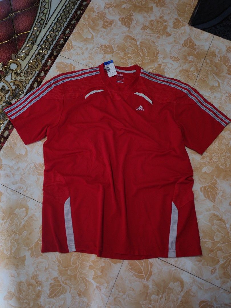 Adidas Climacool Red Athletic T-Shirt (Category: Shirts) located in Baguio. Submitted by eplerkate99908 (Listing ID 1466351428, Image 1). Description: - Brand: Adidas Clima365 - Color: Bright red with white logo and stripes - Condition: Thrift store tag still attached - Material/Design: Breathable honeycomb mesh texture on upper chest - Features: Short sleeves and classic three-stripe shoulder detailing - Ideal for: Gym, running, and athletic tra
