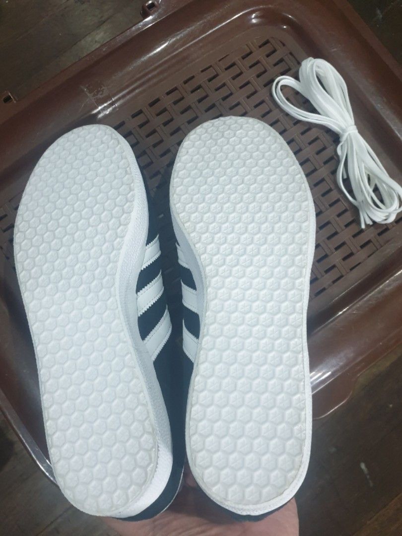 Adidas Gazelle (Category: Casual Shoes) located in Quezon City. Submitted by jumbotron (Listing ID 1466446492, Image 3). Description: - Brand: Adidas - Color: Black suede with white stripes and laces - Style: Classic low-top design - Condition: Pristine clean white outsoles with zero wear on treads - Inclusions: Extra pair of white laces included - Perfect for: Comfortable daily wear - No Box.