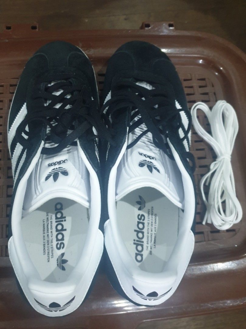 Adidas Gazelle (Category: Casual Shoes) located in Quezon City. Submitted by jumbotron (Listing ID 1466446492, Image 2). Description: - Brand: Adidas - Color: Black suede with white stripes and laces - Style: Classic low-top design - Condition: Pristine clean white outsoles with zero wear on treads - Inclusions: Extra pair of white laces included - Perfect for: Comfortable daily wear - No Box.