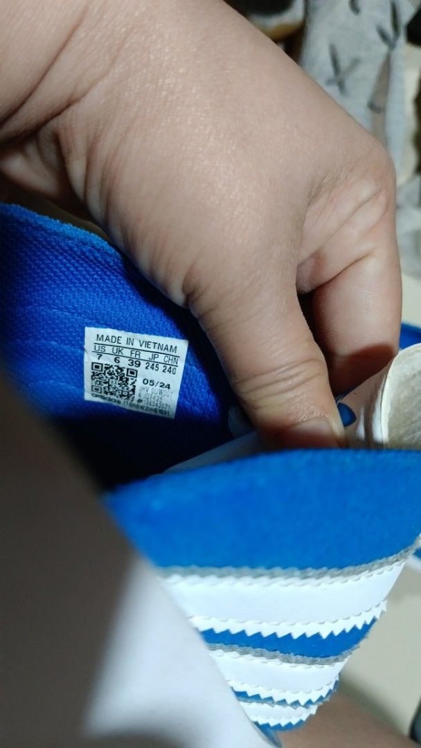Adidas Gazelle Slides Blue White (Category: Slippers & Slides) located in Manila. Submitted by zariyah.1986 (Listing ID 1466439465, Image 2). Description: - Item: Adidas Gazelle slides - Color: Blue and white with classic three stripes and decorative laces - Size: US 7 / UK 6 / FR 39 / JP 245 / CHN 240 - Material: Suede upper with white footbed - Details: Adidas branding and Gazelle text on the side, made in Vietnam (Date code: 05/24) - Condition