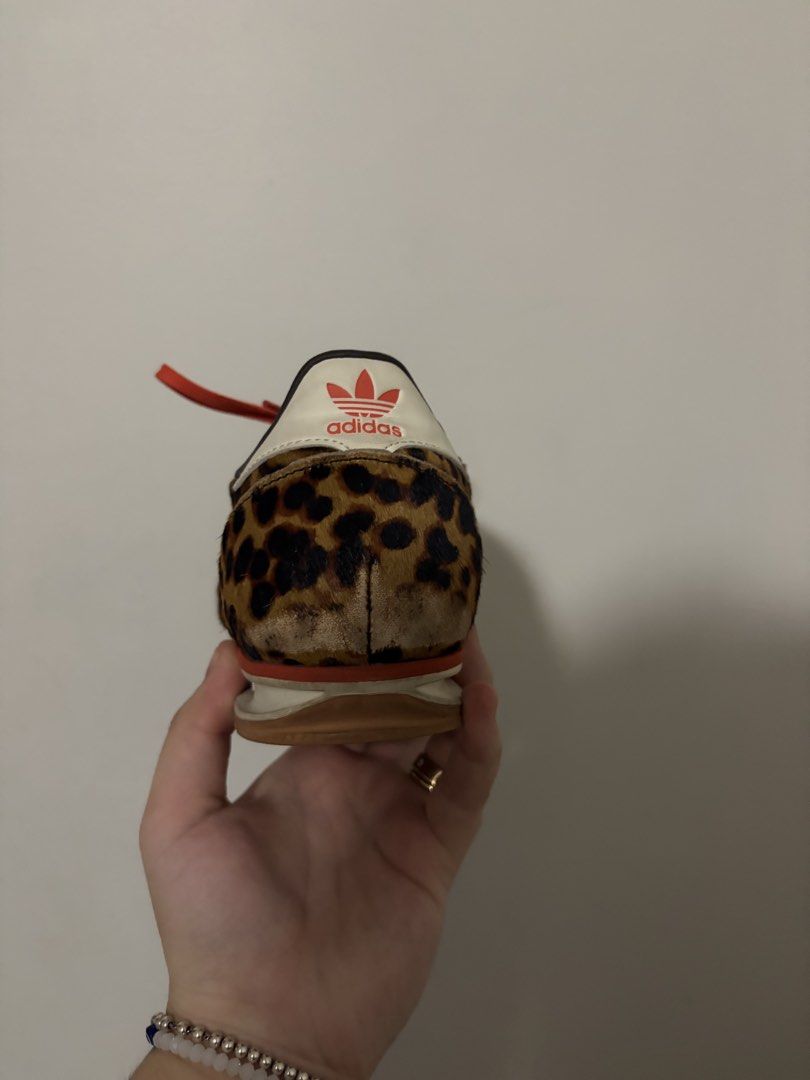 Adidas Leopard Print Sneakers with Orange Laces (Category: Sneakers) located in Paranaque City. Submitted by clxsetfinds.co (Listing ID 1466451216, Image 3). Description: - RUSH SALE PLEASE HUHU WILLING TO NEGOTIATE - Brand: Adidas - Design: Wild leopard print hair-on-calf upper with iconic white three stripes - Accents: Bold orange laces and white heel tab with red trefoil logo - Sole: Brown rubber outsole with textured grip - Interior: Dark fab