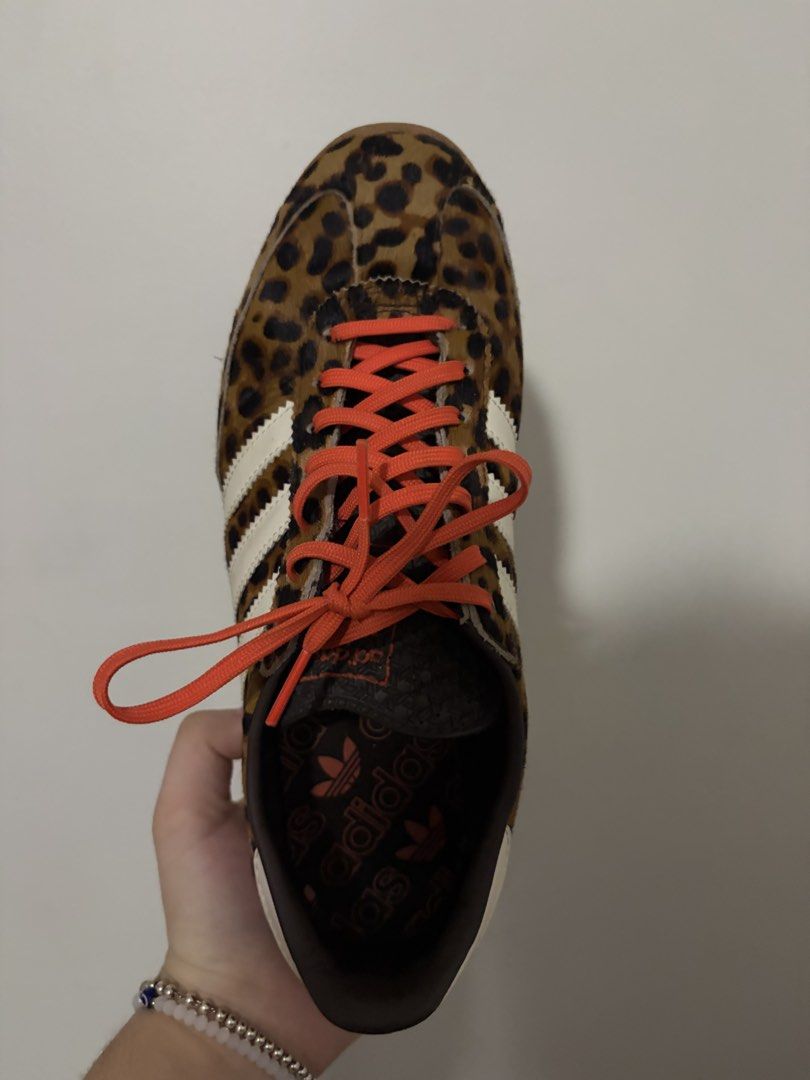 Adidas Leopard Print Sneakers with Orange Laces (Category: Sneakers) located in Paranaque City. Submitted by clxsetfinds.co (Listing ID 1466451216, Image 2). Description: - RUSH SALE PLEASE HUHU WILLING TO NEGOTIATE - Brand: Adidas - Design: Wild leopard print hair-on-calf upper with iconic white three stripes - Accents: Bold orange laces and white heel tab with red trefoil logo - Sole: Brown rubber outsole with textured grip - Interior: Dark fab