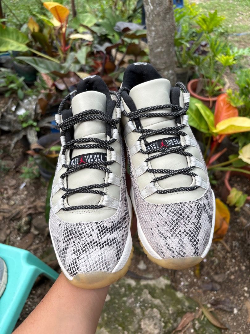 Air Jordan 11 Retro Low Light Bone Snakeskin (Category: Sneakers) located in Danao, Cebu. Submitted by kentoy25 (Listing ID 1466426450, Image 3). Description: - Model: Air Jordan 11 Retro Low (Light Bone / Snakeskin) - Size: US 8.5 / UK 7.5 / EUR 42 / CM 26.5 - Details: White leather upper, black inner lining, patterned laces - Sole: Translucent rubber outsole with carbon fiber plate (minor yellowing from age/use) - Condition: Inside tag intact, 