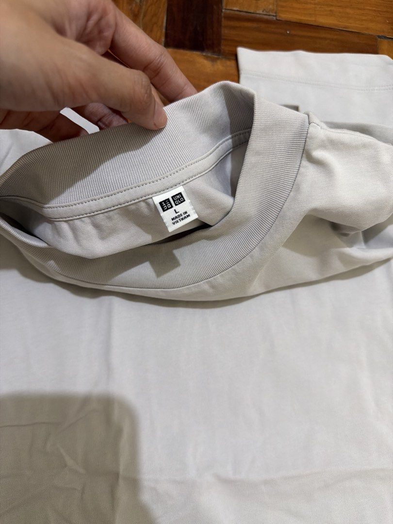 airism uniqlo shirt (Category: Shirts) located in Manila. Submitted by wearagainfinds (Listing ID 1466416222, Image 2). Description: - Color: Light grey and light pink - Sold per piece - Fit: Relaxed, oversized S-L - Design: Crew neckline, short sleeves, and side slits at the hem for easy movement - Fabric: Thick, structured material that holds its shape well - Styling: Versatile neutral tone that pairs great with jeans or joggers.