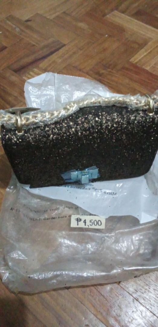 Aldo Glitter Crossbody Bag with Chain Strap (Category: Cross-body Bags) located in Marikina City. Submitted by silentstar_3bba68 (Listing ID 1466480145, Image 1). Description: - Brand: Aldo - Style: Glitter crossbody bag - Color: Dark bronze / black tone with gold-tone hardware - Closure: Flap front with twist lock - Condition: Brand new with original tag (₱4,500) attached, never used - Extras: Chain strap still wrapped in protective plastic, sto