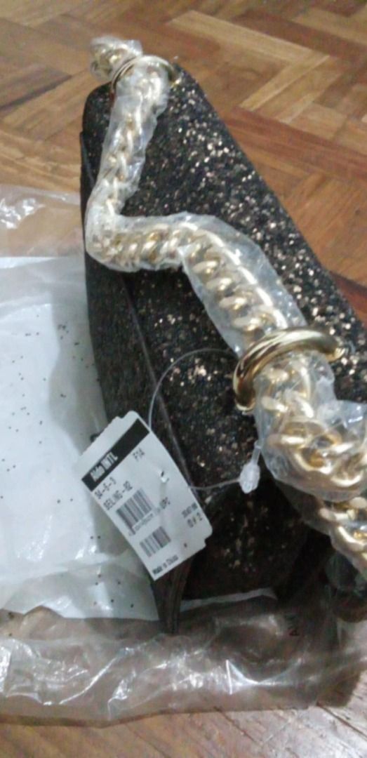 Aldo Glitter Crossbody Bag with Chain Strap (Category: Cross-body Bags) located in Marikina City. Submitted by silentstar_3bba68 (Listing ID 1466480145, Image 3). Description: - Brand: Aldo - Style: Glitter crossbody bag - Color: Dark bronze / black tone with gold-tone hardware - Closure: Flap front with twist lock - Condition: Brand new with original tag (₱4,500) attached, never used - Extras: Chain strap still wrapped in protective plastic, sto