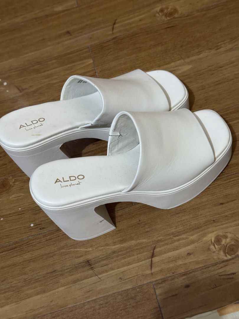 Aldo Maysee White Platform Heels US 8.5 (Category: Heels) located in Pasig City. Submitted by authentic_preloved_by_elca (Listing ID 1466453594, Image 1). Description: - Brand: Aldo - Model: Maysee White Platform Heels - Size: US 8.5 (EUR 39 / UK 6) - Color: White - Style: Chunky block heel with thick platform sole and wide upper strap - Condition: Authentic and Pre-loved, clean upper body with normal signs of wear on the bottom soles - Great add