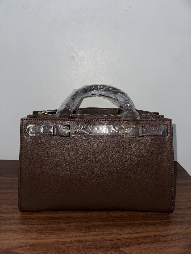 Aldo Top Handle Bag (Dark Brown) (Category: Shoulder Bags) located in Manila. Submitted by elleflores (Listing ID 1466473974, Image 2). Description: - Brand: Aldo Elizabelle Top Handle Bag - Color: Dark Brown with elegant gold-tone hardware - Material: Premium textured faux leather - Condition: Brand new, never used, with original store tag attached - Protection: Hardware and handles still wrapped in original protective plastic - Features: Secure