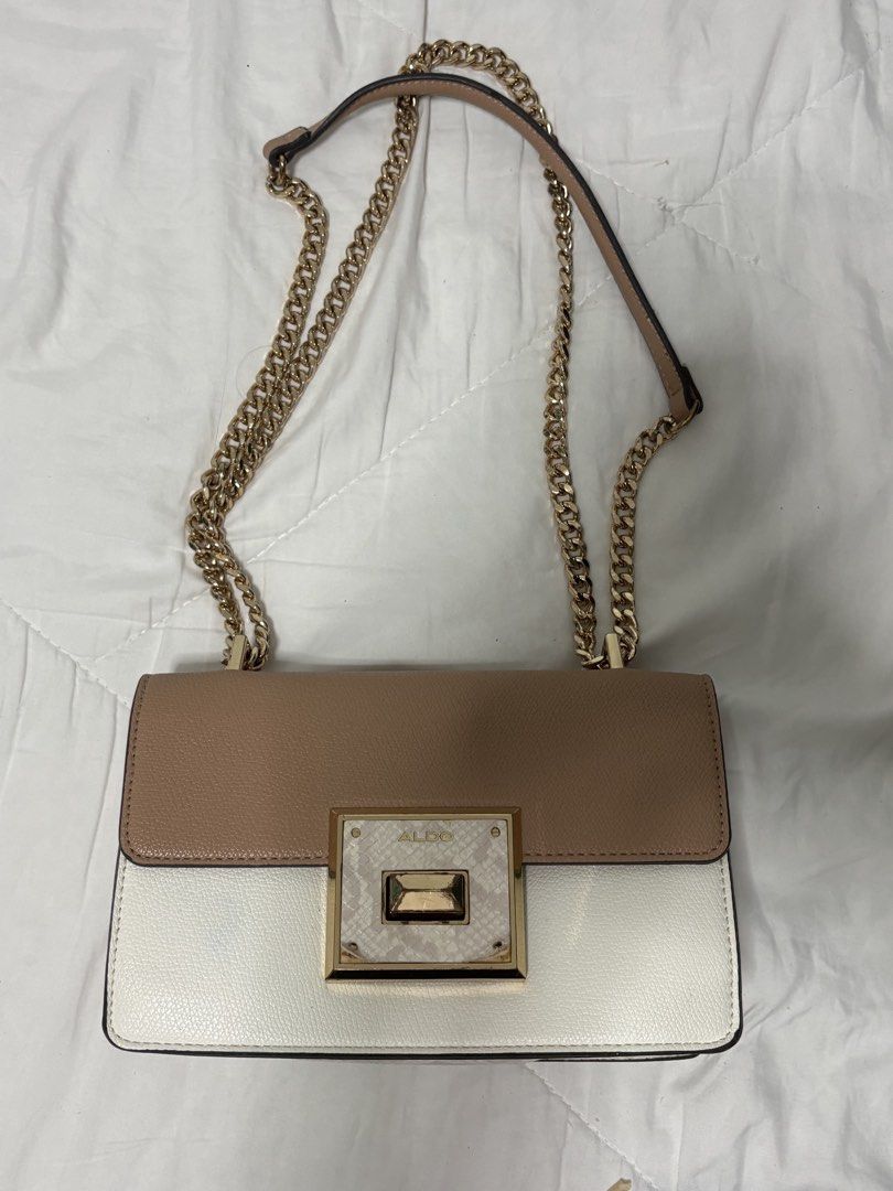 ALDO Two-Tone Shoulder Bag with Gold Chain (Category: Shoulder Bags) located in Marikina City. Submitted by sc00007 (Listing ID 1466467504, Image 3). Description: - Brand: ALDO - Color: Beige and white color block - Hardware: Gold tone with chain strap - Design: Structured flap with textured lock closure - Size: Compact (ideal for daily essentials or evening outings) - Condition: Clean interior issue: posted. .