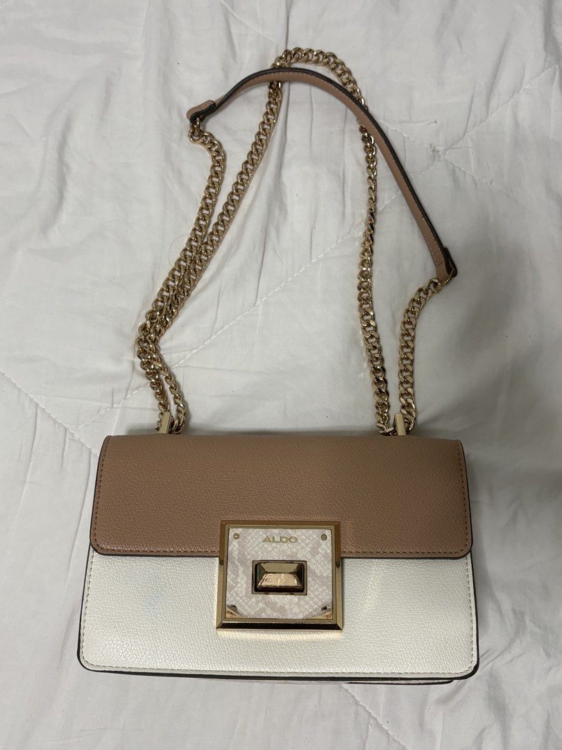 ALDO Two-Tone Shoulder Bag with Gold Chain (Category: Shoulder Bags) located in Marikina City. Submitted by sc00007 (Listing ID 1466467504, Image 2). Description: - Brand: ALDO - Color: Beige and white color block - Hardware: Gold tone with chain strap - Design: Structured flap with textured lock closure - Size: Compact (ideal for daily essentials or evening outings) - Condition: Clean interior issue: posted. .
