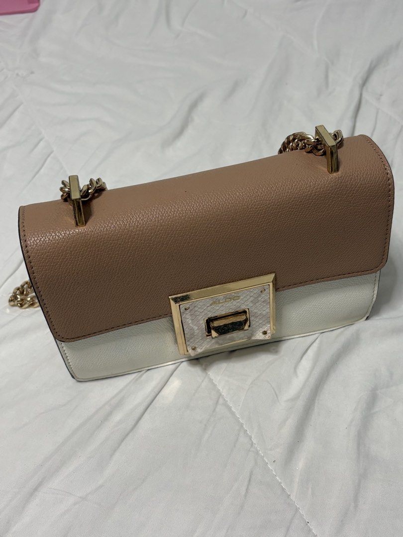ALDO Two-Tone Shoulder Bag with Gold Chain (Category: Shoulder Bags) located in Marikina City. Submitted by sc00007 (Listing ID 1466467504, Image 1). Description: - Brand: ALDO - Color: Beige and white color block - Hardware: Gold tone with chain strap - Design: Structured flap with textured lock closure - Size: Compact (ideal for daily essentials or evening outings) - Condition: Clean interior issue: posted. .