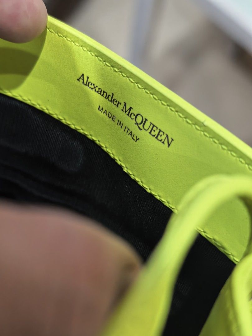 Alexander McQueen (Category: Cross-body Bags) located in Cagayan de Oro. Submitted by tommygurl1218 (Listing ID 1466429584, Image 2). Description: - Brand: Alexander McQueen - Color: Bright neon yellow with contrast stitching - Material: Premium leather with black fabric interior lining - Origin: Made in Italy - Design: Structured vertical shape, silver front lettering, and debossed AM monogram on the back - Mode of Payment: GCash, BPI, or Bank T
