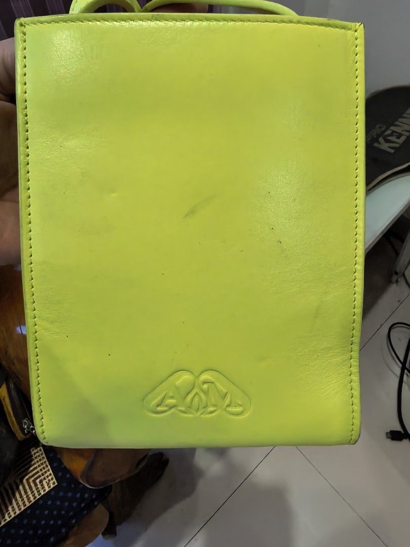 Alexander McQueen (Category: Cross-body Bags) located in Cagayan de Oro. Submitted by tommygurl1218 (Listing ID 1466429584, Image 3). Description: - Brand: Alexander McQueen - Color: Bright neon yellow with contrast stitching - Material: Premium leather with black fabric interior lining - Origin: Made in Italy - Design: Structured vertical shape, silver front lettering, and debossed AM monogram on the back - Mode of Payment: GCash, BPI, or Bank T