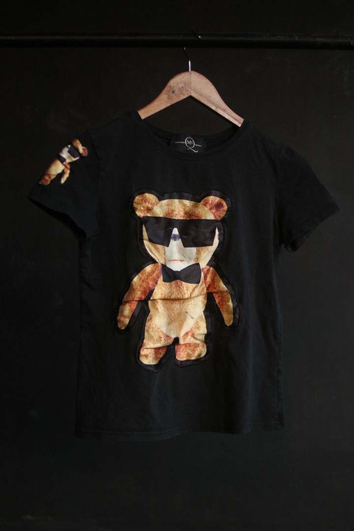 Alexander McQueen Black Bear Graphic T-Shirt (Category: Tshirts & Polo Shirts ) located in Taguig. Submitted by kurim4w (Listing ID 1466443977, Image 1). Description: - Brand: Alexander McQueen - Color: Black - Style: Short-sleeve t-shirt / Standard fit - Material: 100% Cotton - Design: Large teddy bear graphic with sunglasses & bow tie on front; small bear detail on right sleeve - Details: Branded neck label stitched inside - Condition: Clean an