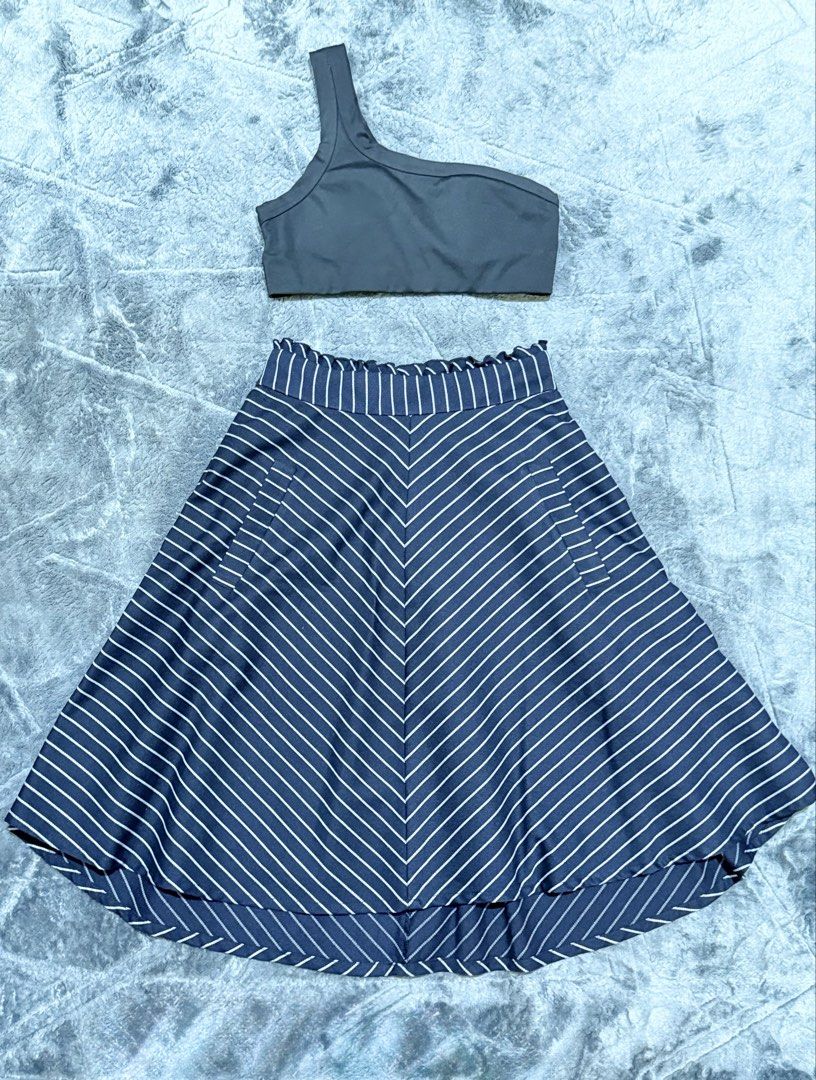 All in Motion & Emse Two-Piece Set (Category: Sets or Coordinates) located in Manila. Submitted by yeti_it (Listing ID 1466439672, Image 1). Description: - All in Motion black one-shoulder top (Size XS) - Navy blue skirt with white diagonal stripes, front pockets, and ruffled elastic waistband - Overall clean condition - Versatile matching set for casual days or workouts - DM for measurements or questions!.