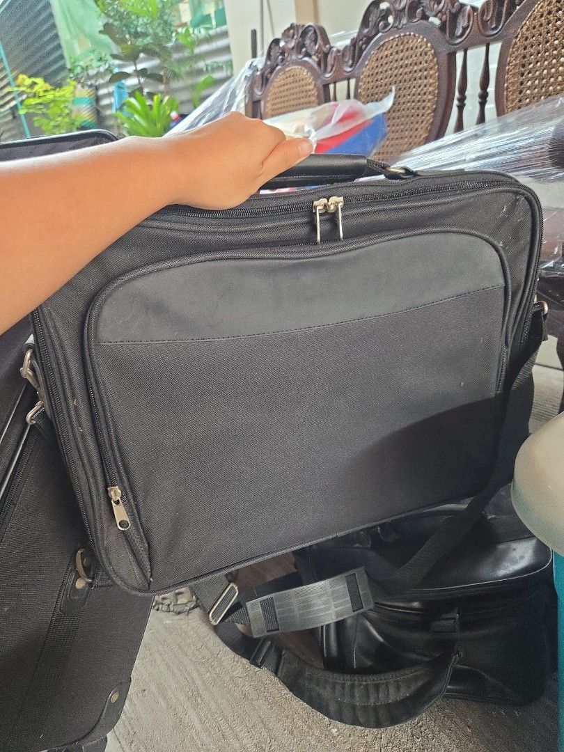 AMBICO Black Laptop Briefcase Shoulder Bag (Category: Briefcases) located in Manila. Submitted by preownedddd (Listing ID 1466344139, Image 1). Description: - Material: Durable black nylon - Storage: Multiple zippered compartments, front pocket, and clean spacious interior for laptops and documents - Comfort: Thick padded shoulder strap and solid top handle - Ideal For: Daily work or school commutes - Condition: Brand new and ready to use.