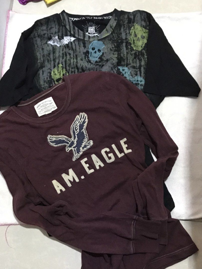 American Eagle Long Sleeve Shirt Maroon Size M (Category: Longsleeves) located in Manila. Submitted by swiftstorm.ace395 (Listing ID 1466379421, Image 1). Description: - Brand: American Eagle Outfitters - Item: Long sleeve tee - Color: Maroon - Size: M (Width: 54.5 cm, Length: 74 cm) - Material: 100% cotton body with acrylic-wool embroidered eagle logo - Fit: Relaxed fit with classic crew neck - Origin: Made in Vietnam - Condition: Excellent, tag