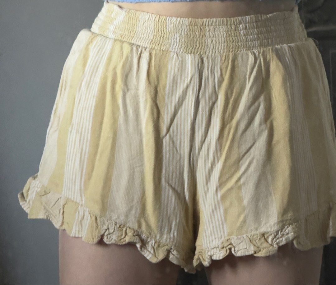 American Eagle Yellow Striped Ruffle Shorts Size Small (Category: Shorts) located in Santa Ana. Submitted by fatikilla (Listing ID 1464810507, Image 3). Description: - Brand: American Eagle - Size: Small (tag attached) - Color/Pattern: Yellow and white stripes - Waistband: Smocked high-rise elastic - Fit & Style: Flowy with ruffled hems, fully lined - Origin: Made in India - Condition: Great casual piece for warm weather.