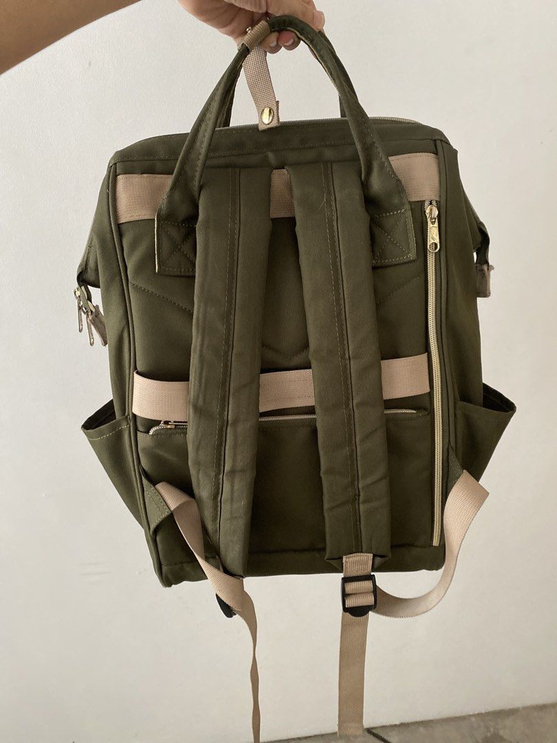 Anello Olive Green Backpack (Category: Backpacks) located in Manila. Submitted by carastaaa (Listing ID 1466428464, Image 2). Description: - Authentic olive green Anello canvas backpack - Signature wide-mouth wire frame opening for easy packing and viewing - Spacious main compartment with convenient rear vertical zipper access - Secure front zipper pocket and dual side slip pockets - Durable fabric with stylish beige accents and snap button handl