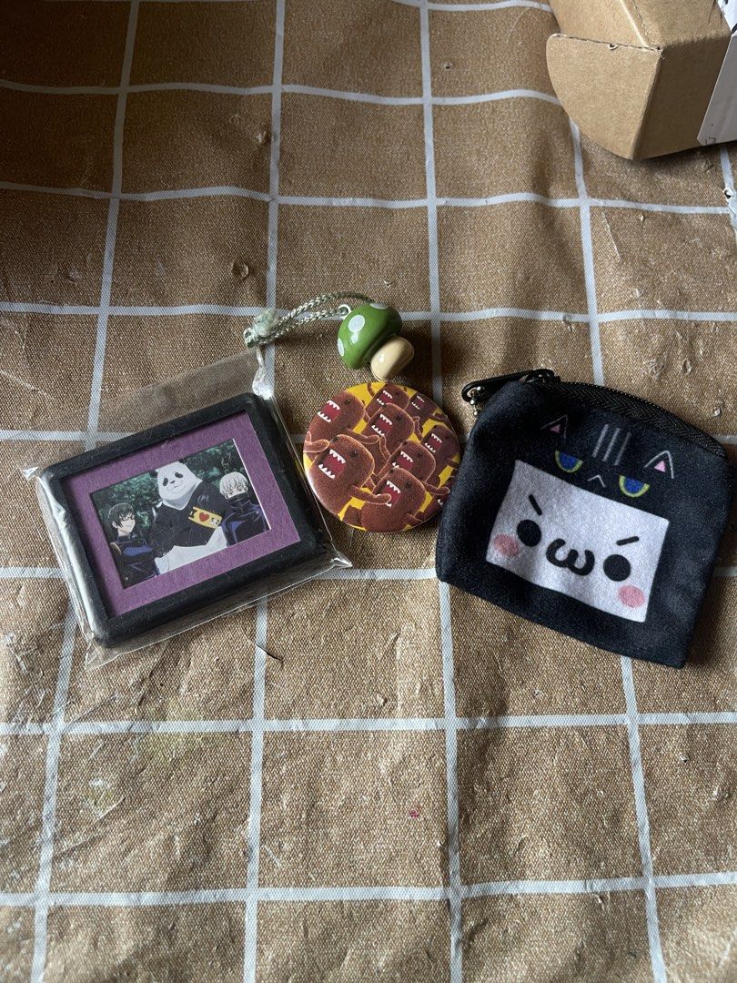 Anime Merch Pins Coin Pouch Keychain (Category: Character Goods) located in Manila. Submitted by lyves0417 (Listing ID 1466410691, Image 1). Description: - Cute mini accessories bundle available - Includes: Jujutsu Kaisen framed mini picture, Domo-kun button pin with green mushroom strap, and black cat face coin pouch - Selling as a set or individually - Condition: Brand new / Well-maintained - PM for individual prices and inquiries.