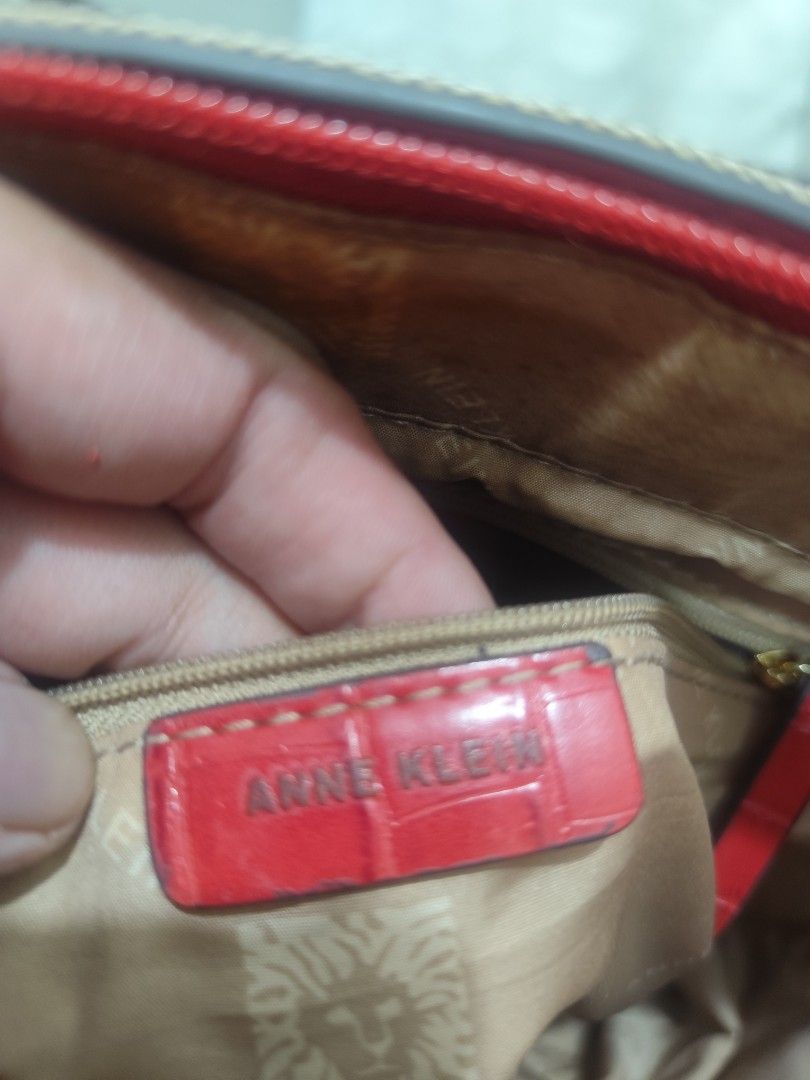 Anne Klein patterned tote bag with red straps (Category: Tote Bags) located in Mandaluyong City. Submitted by mommytinderella (Listing ID 1466477185, Image 3). Description: Anne Klein tote bag in a brown geometric print. Bright red faux crocodile textured straps with gold-tone buckles. Zip-top closure. Interior lined with beige logo fabric, featuring a zippered pocket and slip pockets. Visible wear and peeling on the red straps, especially near t
