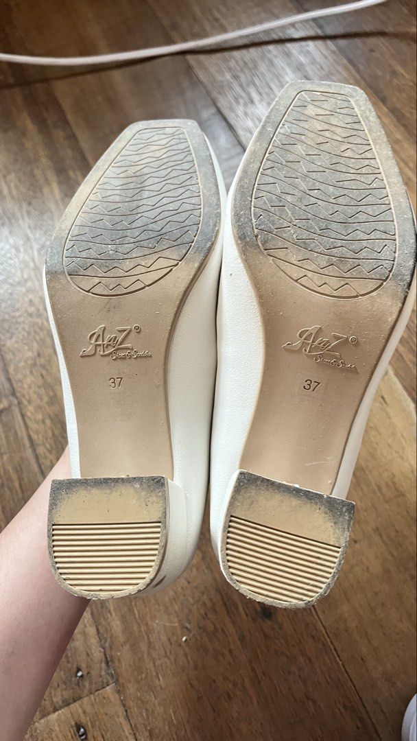 AnZ White Block Heel Pumps Size 37 (Category: Heels) located in Manila. Submitted by ayessaset53754 (Listing ID 1466377954, Image 2). Description: White block heel pumps from AnZ. Size 37. Square toe design with beige inner lining. Chunky low heel provides stable walking support. Issue: Minor scuff marks near the toe tip and a small stain on the heel as pictured. Soles show normal wear from previous use..