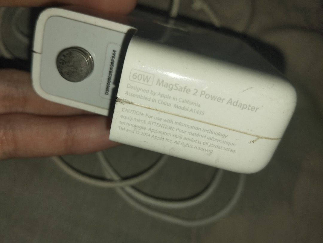 Apple 60W MagSafe 2 Power Adapter Model A1435 (Category: Chargers) located in Manila. Submitted by rodderifk (Listing ID 1466549926, Image 3). Description: Original Apple 60W MagSafe 2 power adapter, model A1435. Input 100-240V, output 16.5V 3.65A. White brick with built-in fold-out plug arms and attach cable ending in magnetic 5-pin T-style connector. Shows some scuffs and general dirt buildup from daily use. Cable strain relief intact at both e