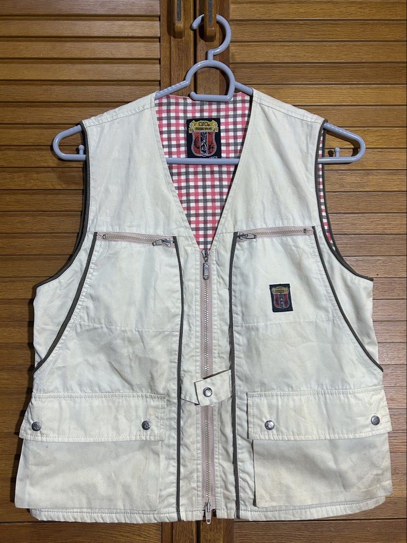 ASICS Beige Vest | y2k 2000s layering (Category: Vests) located in Manila. Submitted by quincy.67 (Listing ID 1466441769, Image 1). Description: - Brand: GIO Fishing Wear (manufactured by Asics) - Color: Cream beige outer with pink and brown plaid inner lining - Size: M - Features: Multiple front pockets with double zipper and snap button closures - Style: Vintage outdoor gear / utility vest.