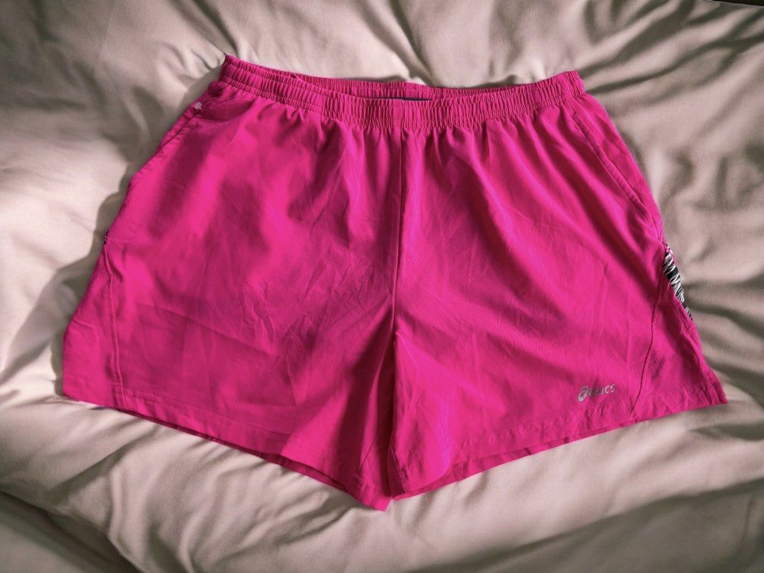 Asics Hot Pink Running Shorts (Category: Activewear) located in Iloilo. Submitted by oddforest.c9c7d5 (Listing ID 1466511710, Image 2). Description: - Brand: Asics - Size: Large - Color: Hot pink with black/white patterned hem - Material: Comfortable polyester and spandex blend (Made in Vietnam) - Features: Built-in gray mesh lining and adjustable pink drawstring - Safety: Reflective Asics logo for low-light visibility - Ideal for: Running, gym w