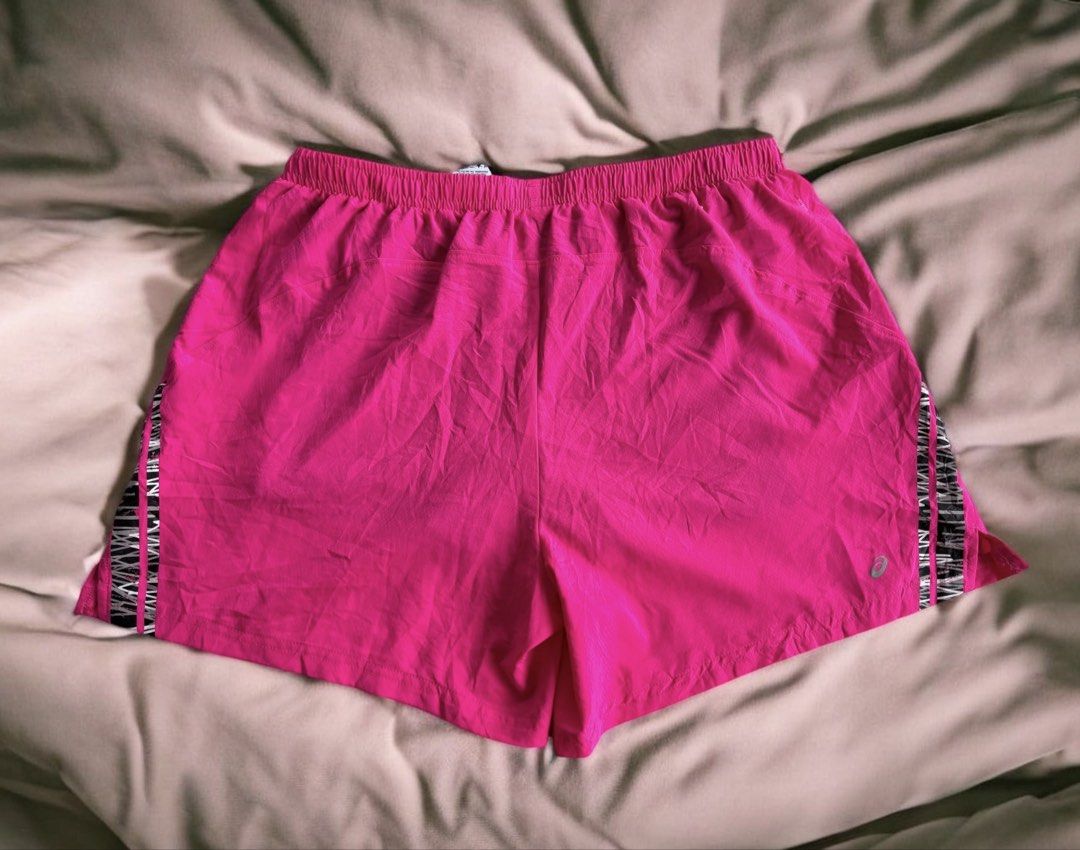 Asics Hot Pink Running Shorts (Category: Activewear) located in Iloilo. Submitted by oddforest.c9c7d5 (Listing ID 1466511710, Image 1). Description: - Brand: Asics - Size: Large - Color: Hot pink with black/white patterned hem - Material: Comfortable polyester and spandex blend (Made in Vietnam) - Features: Built-in gray mesh lining and adjustable pink drawstring - Safety: Reflective Asics logo for low-light visibility - Ideal for: Running, gym w