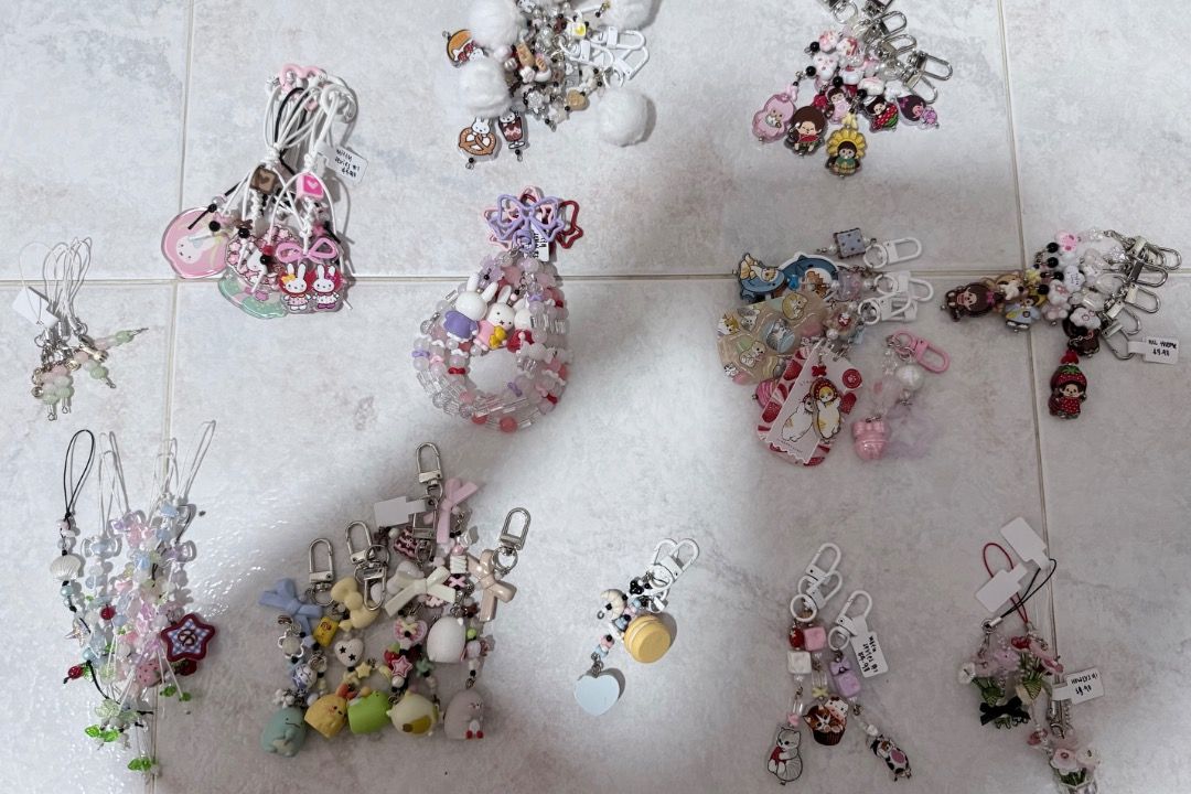 Assorted keychains (Category: Charms) located in Singapore. Submitted by randomhere (Listing ID 1466442008, Image 1). Description: - Lot of handmade-style charms, phone straps, and bag accessories - Features beaded designs, little figures, bows, and character charms - Color palette includes pink, white, pastel, and multicolored pieces - Versatile use for phones, keys, or bags - Sold as a complete set together as pictured Take all for $14 (not for
