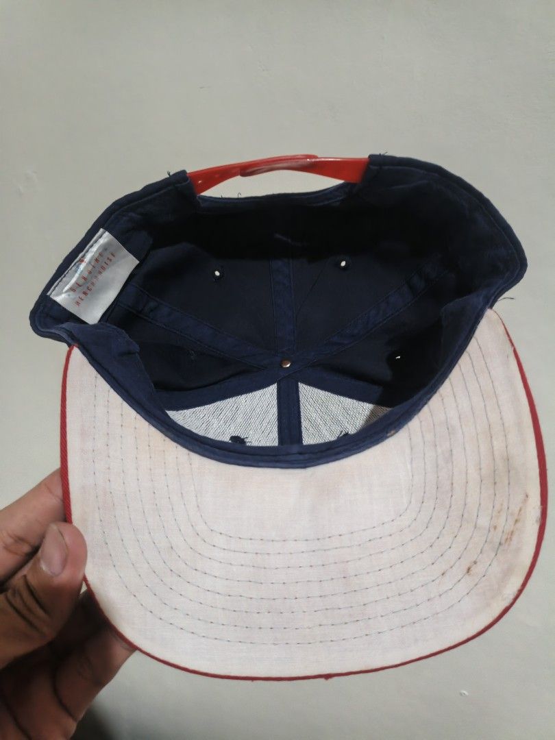 Atlanta Braves MLB Snapback Cap Navy Red (Category: Caps & Hats) located in San Jose. Submitted by ezsenthrift475 (Listing ID 1466351962, Image 2). Description: - Authentic Atlanta Braves snapback cap in navy blue and red - Features embroidered classic 'A' logo on the front and scripted 'Braves' text with tomahawk on the side - Adjustable red plastic snapback closure for a custom fit - Genuine Merchandise label attached inside - Flaw note: White 