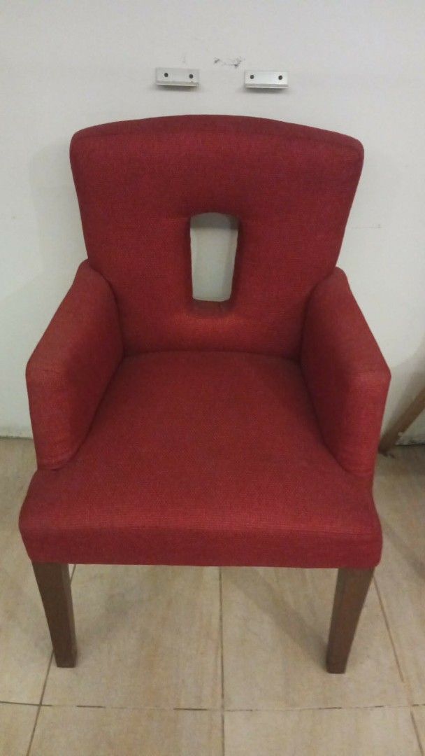 Attractive Red Upholstered Armchair with Cutout Back (Category: Chairs) located in Las Pinas. Submitted by jesus1smysavi0r (Listing ID 1466367148, Image 2). Description: - Bold red upholstered armchair with stylish textured fabric - Unique rectangular cutout window detail on the backrest - Solid wood frame and legs in a neutral brown finish - Supportive armrests for maximum comfort - Versatile accent piece ideal for living rooms, bedrooms, or stu